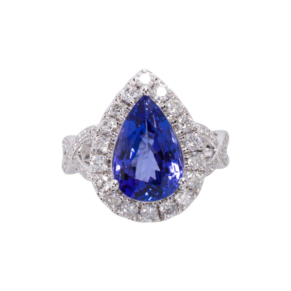 A tanzanite, diamond, and 14k white gold ring: A tanzanite, diamond, and 14k white gold ring Centering a pear-cut tanzanite weighing approximately 3.95 carats, with round brilliant-cut diamond surround and shoulders; estimated total diamond weight