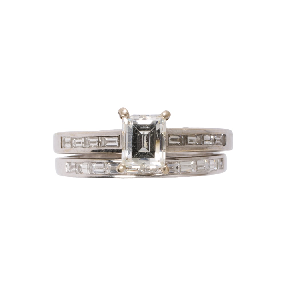 A diamond and 18k white gold engagement ring set: A diamond and 18k white gold engagement ring set Comprising one ring set with an emerald-cut diamond weighing approximately 0.85 carat, accented by baguette-cut diamond shoulders, together with a ring