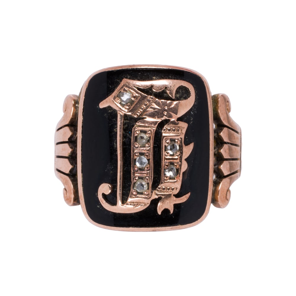 An antique onyx, diamond, and 14k rose gold men's signet ring: An antique onyx, diamond, and 14k rose gold men's signet ring Featuring rose-cut diamond set lettering overlaid on an onyx tablet, with Greco-Roman style shoulders; size 10 1/2; 7.45 grams