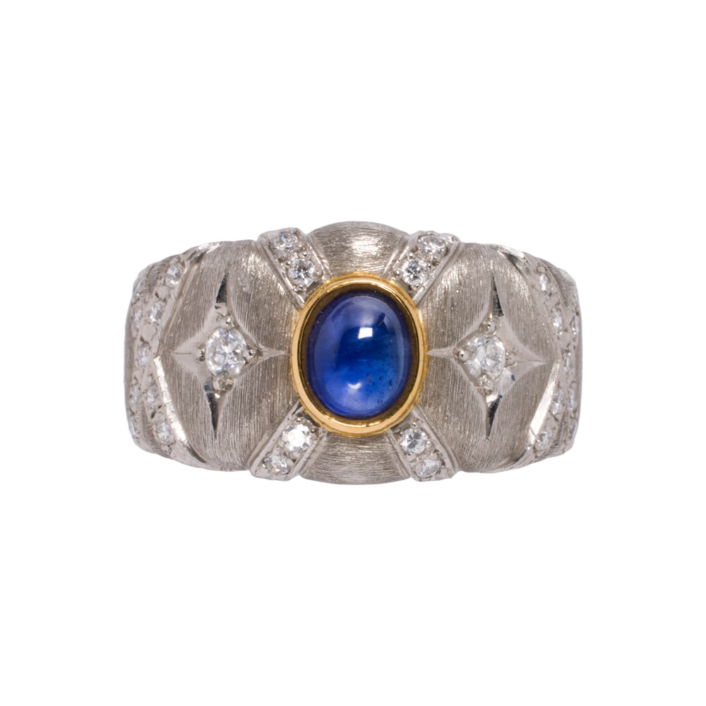 A sapphire, diamond, platinum, and 18k gold ring: A sapphire, diamond, platinum, and 18k gold ring Centering an oval-shaped sapphire cabochon weighing 0.94 carat, on quilted shank set with round brilliant-cut diamonds; size 8; 14.35 grams