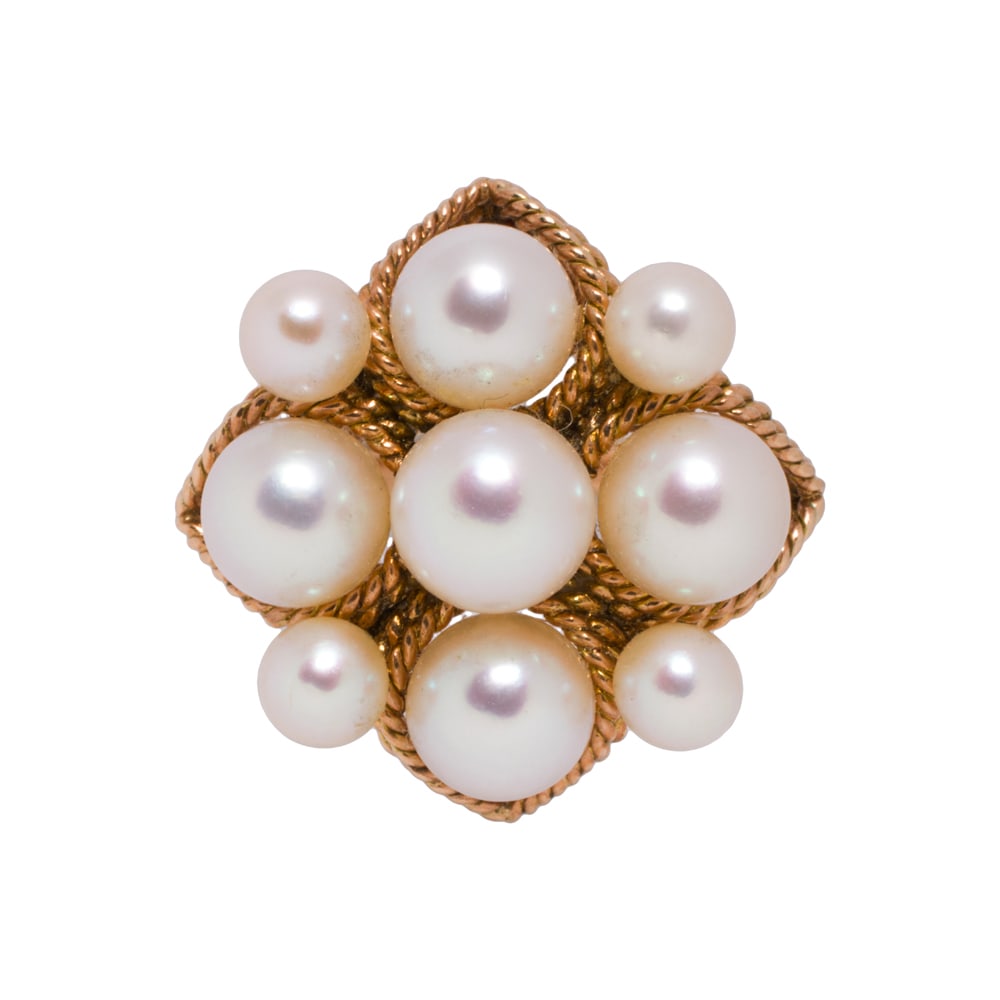 A cultured pearl and 14k gold ring: A cultured pearl and 14k gold ring The ring set with nine cultured pearl measuring from 4.15 to 5.70 mm, accented by twisted wire; size 6; 5.95 grams
