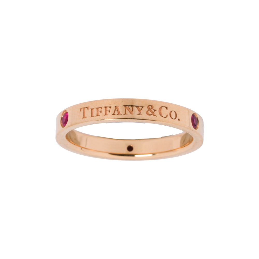 A Tiffany & Co. ruby and 18k gold band: A Tiffany & Co. ruby and 18k gold band Inscribed "Tiffany & Co.", set with three round-cut rubies; size 7; 3.75 grams