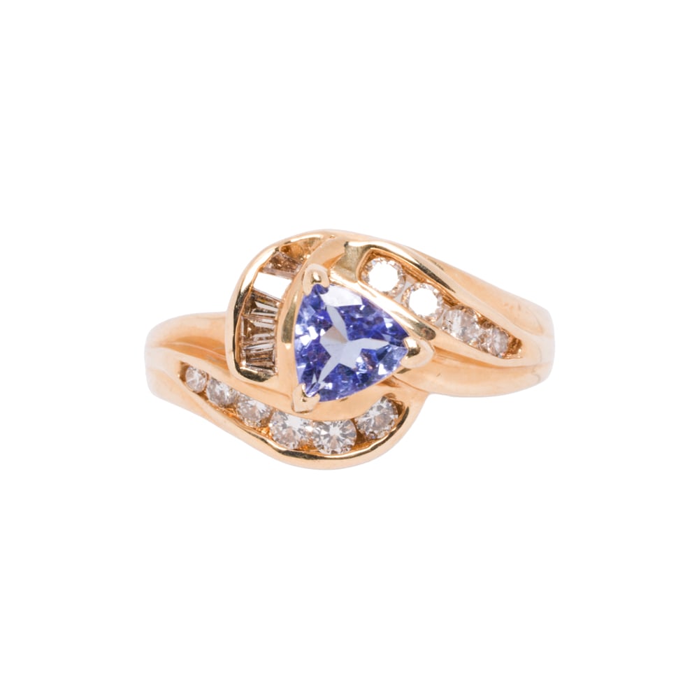 A tanzanite, diamond, and 14k gold ring: A tanzanite, diamond, and 14k gold ring Centering a trillion-cut tanzanite, framed by baguette and round brilliant-cut diamonds; estimated total diamond weight: 0.50 carat; size 7 1/2; 4.45 grams