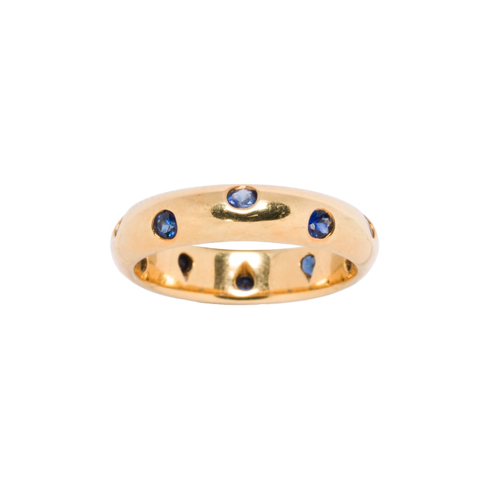 A Tiffany & Co. sapphire and 18k gold band: A Tiffany & Co. sapphire and 18k gold band Set with ten round-cut sapphires; size 5 1/2; 4.75 grams