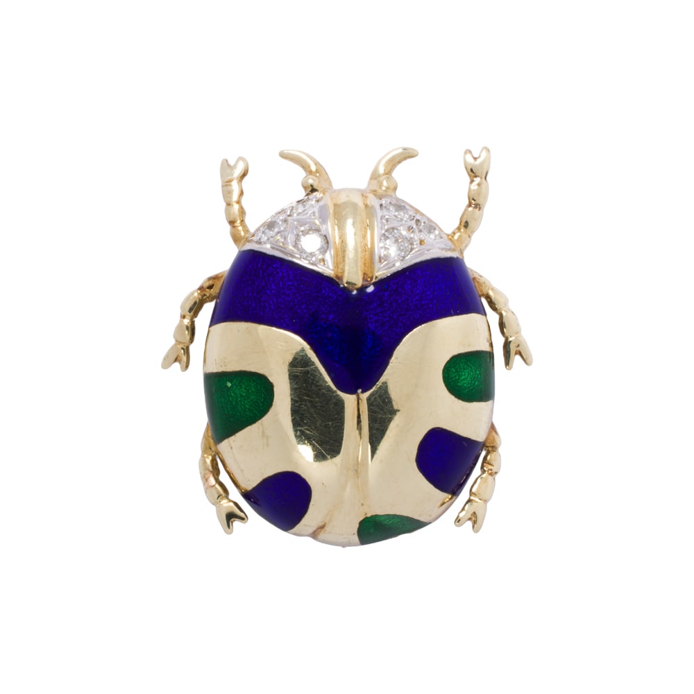 A diamond, enamel and 14k gold beetle brooch: A diamond, enamel and 14k gold beetle brooch with round brilliant-cut diamond set head and enamel accents; length: 1 in; 5.80 grams