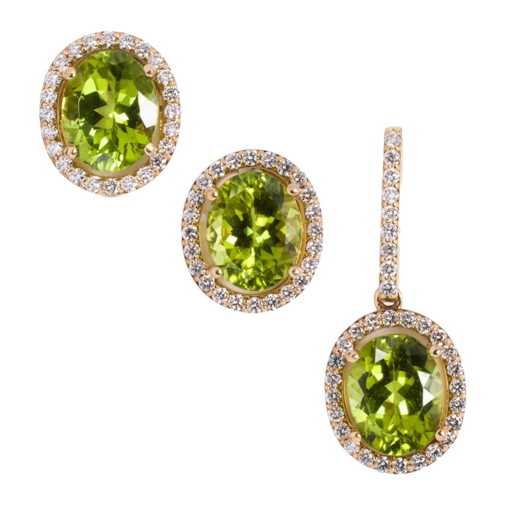 A peridot, diamond and 14k gold set: A peridot, diamond and 14k gold set comprising a pair of earrings and pendant all centering an oval-cut peridot measuring approximately 10.00 x 7.95 x 5.20 mm, framed by round brilliant-cut diamonds;