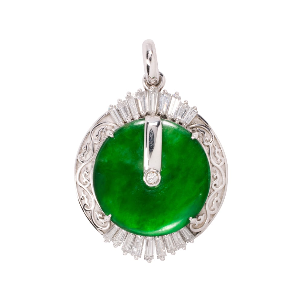 A jade, diamond, and platinum pendant: A jade, diamond, and platinum pendant Centering a jade bi disc measuring 15.91 mm across, accented by one round brilliant and 18 tapered baguette-cut diamonds; estimated total diamond weight: 0.70