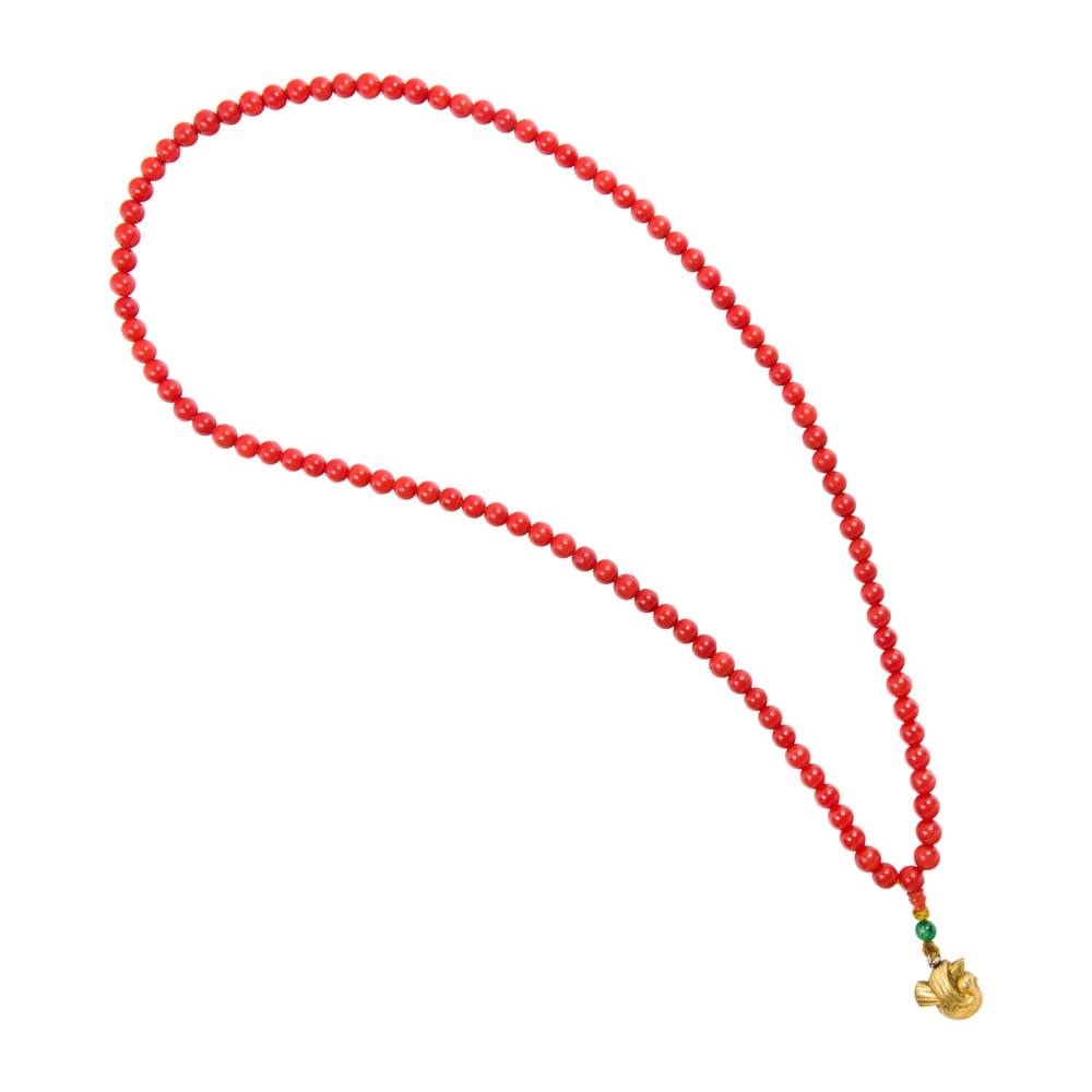 A coral and jade bead worry beads: A coral and jade bead worry beads composed of coral beads measuring approximately 7.1mm, to a jade bead and dimensional gold-filled bird pendant; length: 23 in; 42.81 grams