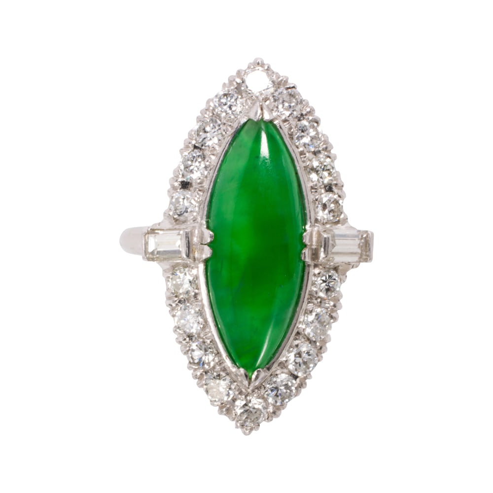 A jade, diamond, and platinum ring: A jade, diamond, and platinum ring Centering a navette-shaped jade cabochon measuring 17.51 x 6.57 x 2.58 mm, framed by 18 round brilliant and baguette-cut diamonds; estimated total diamond weight: