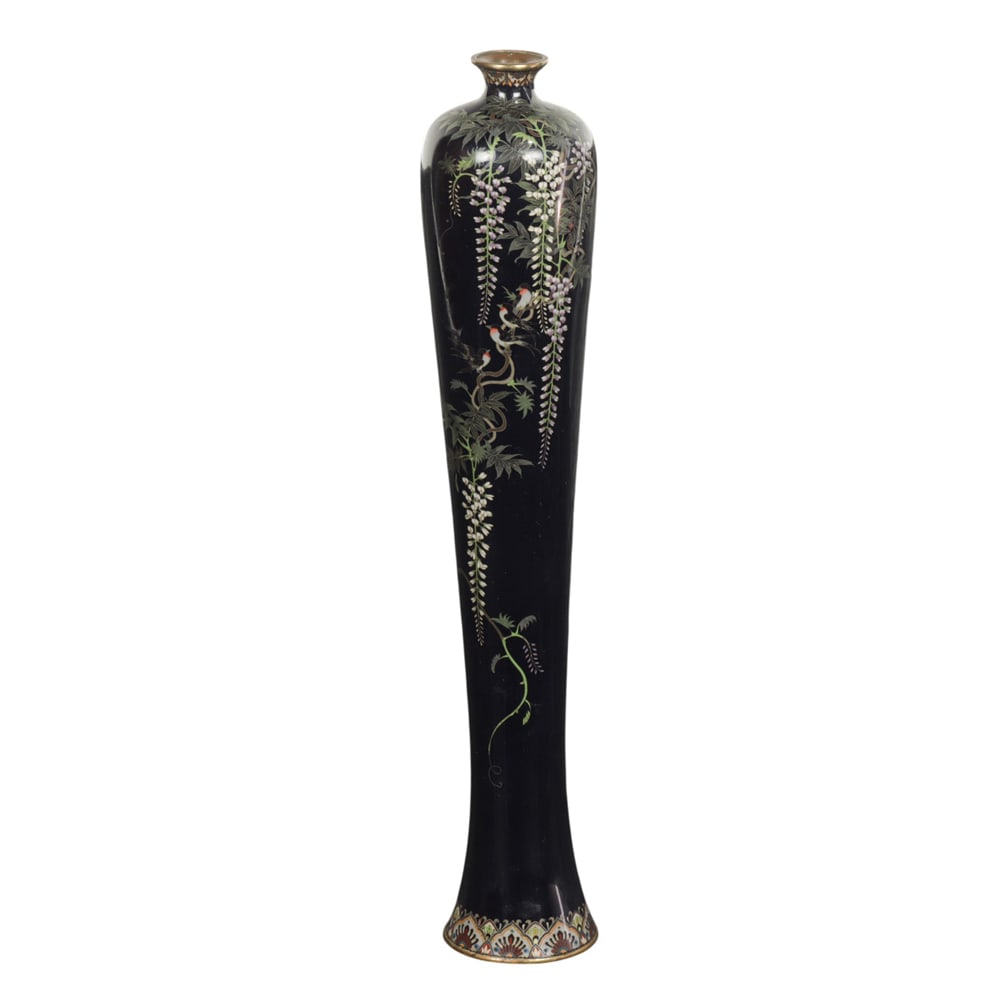 A Japanese cloisonne enamel 'wisteria' vase: A Japanese cloisonne enamel 'wisteria' vase. Of slender tapering form an decorated with wisterias on a black ground, attributed to Hayashi. late Meiji period, 12" high.