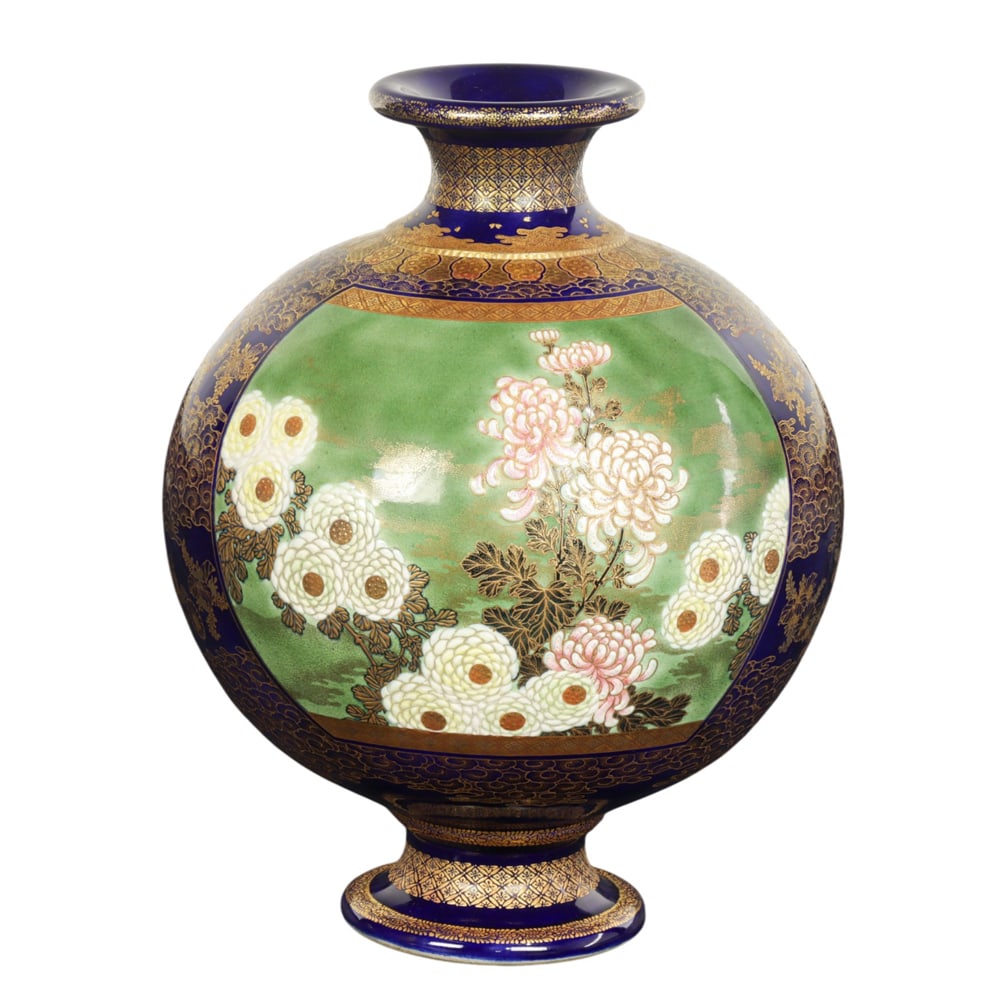 A Japanese Satsuma globular vase by Kinkozan: A Japanese Satsuma globular vase by Kinkozan. Depicting peony blossoms and butterflies reserved on a green ground panel, surrounded by cobalt-blue ground with gilt floral design, featuring an