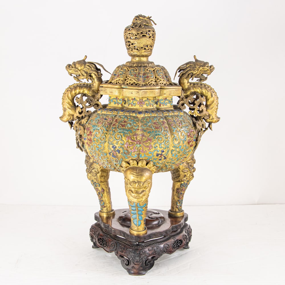 A Chinese champleve enamel tripod censer and cover: A Chinese champleve enamel tripod censer and cover. Of compressed globular form, body raised on three legs, decorated with stylized lotus blossoms with scrolling foliage against a gilt ground, the