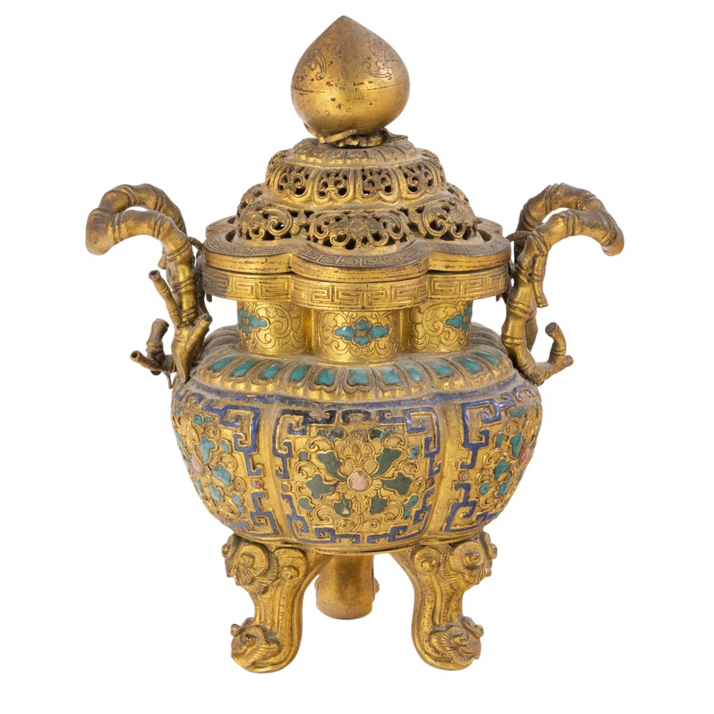 A Chinese champleve enamel and gilt bronze tripod censer: A Chinese champleve enamel and gilt bronze tripod censer. Of lobbed form and flanked by a pair of bamboo-form handles, the bulbous body is decorated with stylized lotus blossoms, all resting on three 