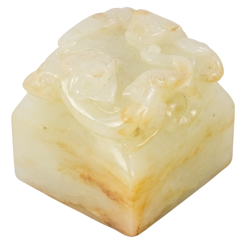 A Chinese russet and white jade seal: A Chinese russet and white jade seal. Featuring pixiu motif, 2" across.