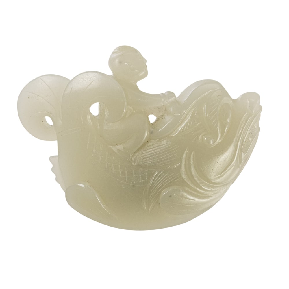 A Chinese white jade carving: A Chinese white jade carving. Showing a boy on a carp, 2.25" across.