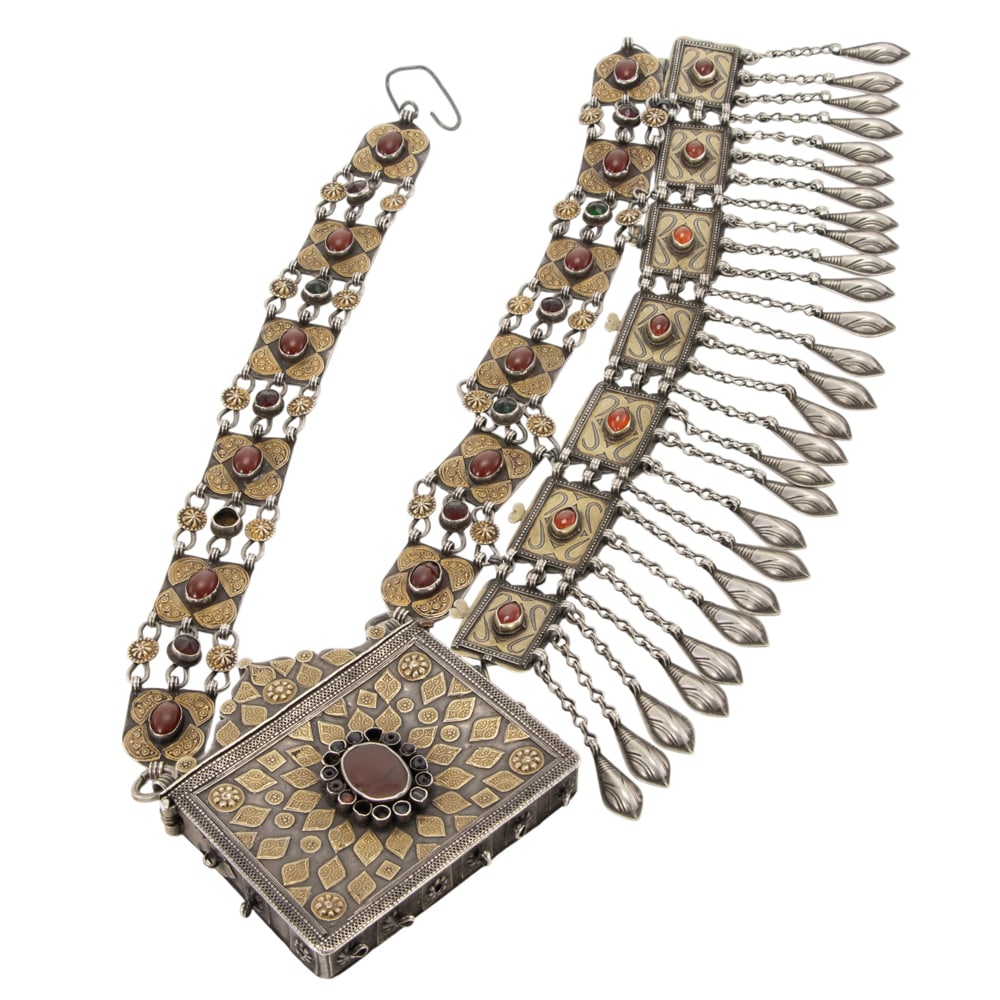 A Tibetan gilt silver and stone inlaid belt: A Tibetan gilt silver and stone inlaid belt. Featuring floral motif, 29.5" long.