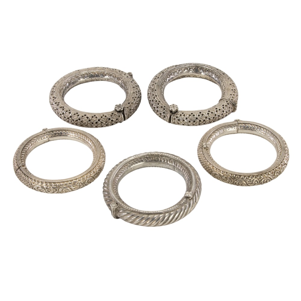 (lot of 5) Tibetan silver bracelet: (lot of 5) Tibetan silver bracelet. Featuring floral motif, from 3.875" to 4.5" across.