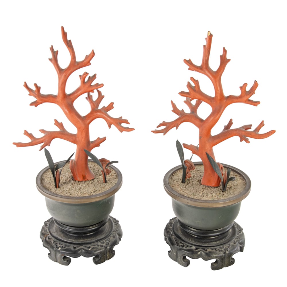A pair of Chinese lacquered wood faux coral branches: A pair of Chinese lacquered wood faux coral branches. Each set in a lacquered a lobed jardiniere and accompanied with similarly lacquered lingzhi and orchid sprigs, 18th/19th century, 10" high.
