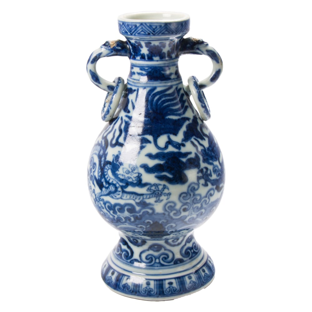 A Chinese blue and white handled vase: A Chinese blue and white handled vase. Decorated with a pair of confronting dragons along with a phoenix and turtle amidst swirling clouds and crashing waves, the each of beast-head handle suspending 