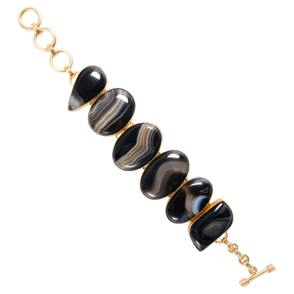 An agate and sterling silver bracelet: An agate and sterling silver bracelet Set with six agate cabochons of varying sizes and shapes; length: 6 1/2 - 8 in; 50.30 grams