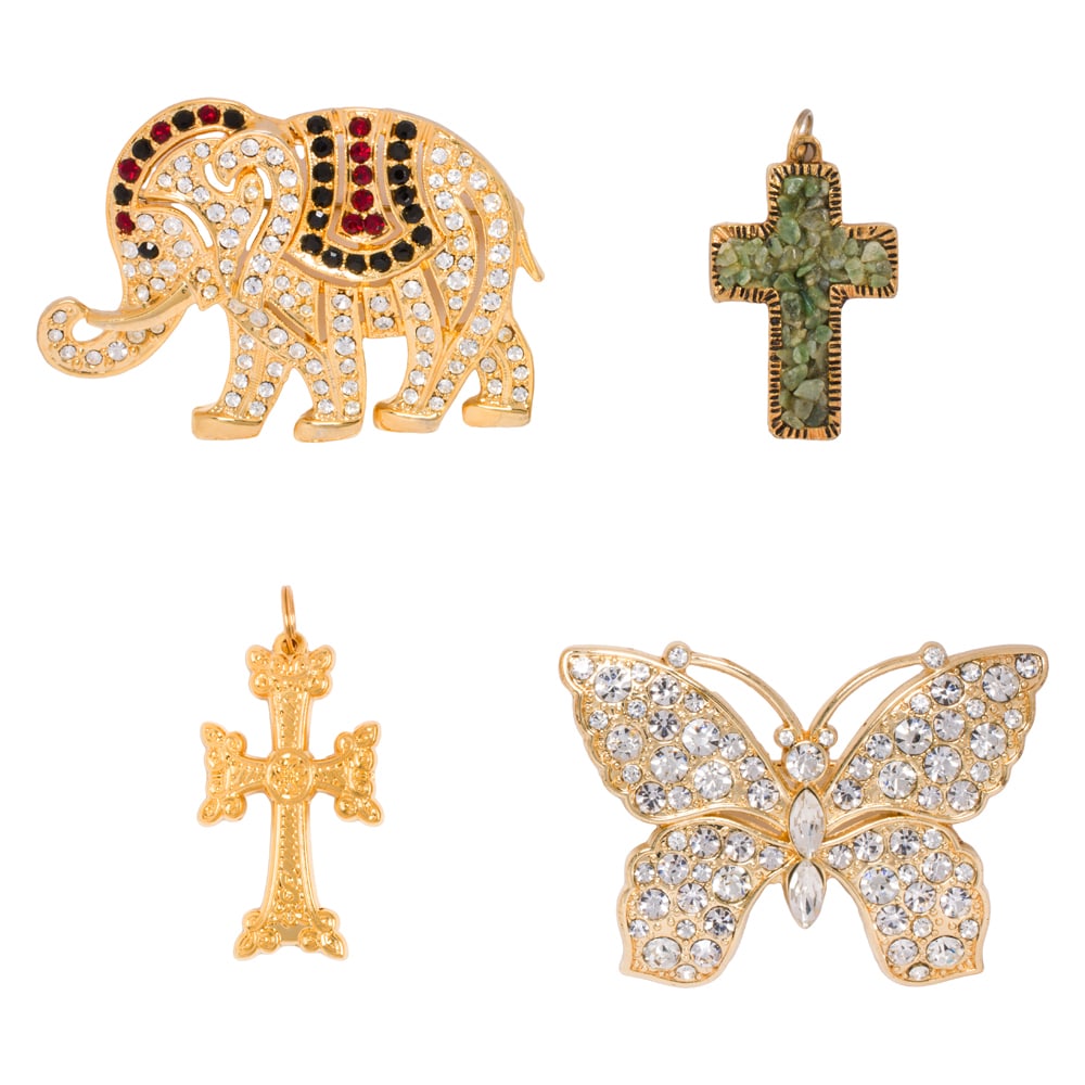 Four pieces of costume jewelry: Four pieces of costume jewelry The costume jewelry of varying designs including a butterfly and crosses; gross weight: 62.30 grams