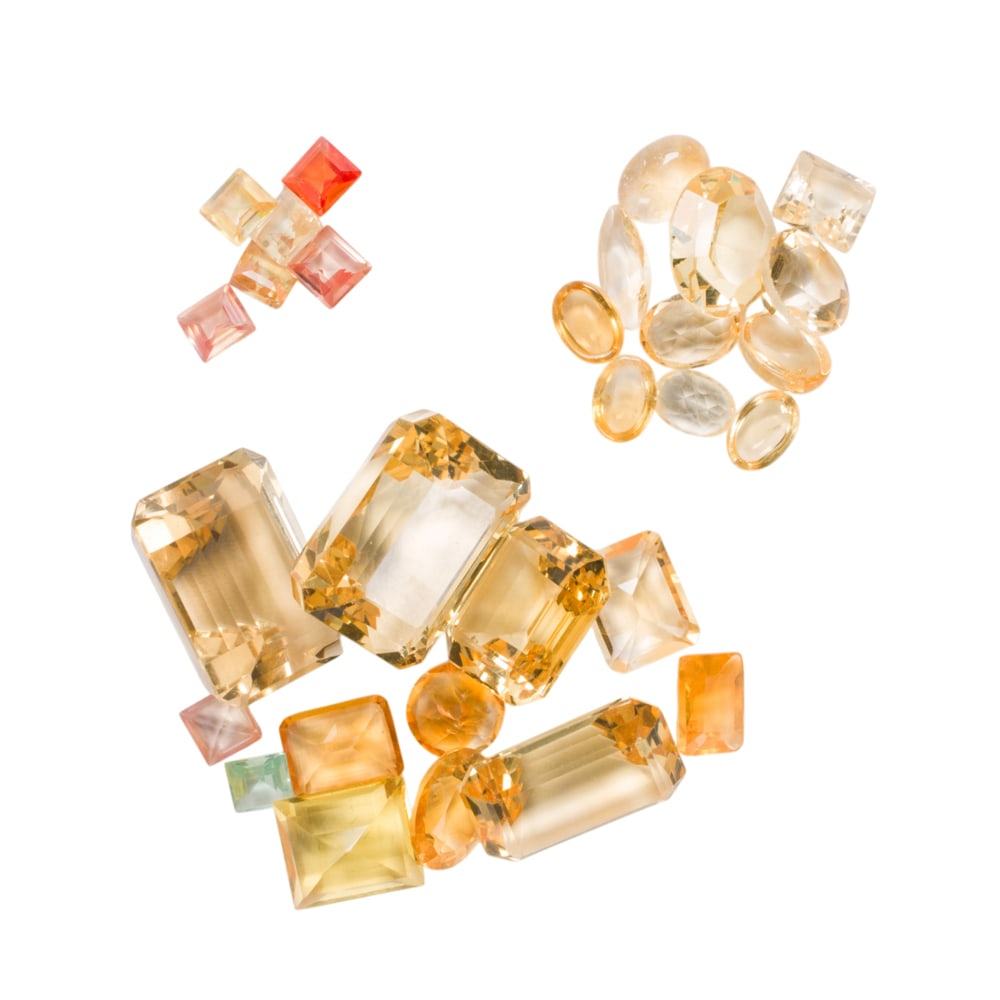 A group of unmounted stones: A group of unmounted stones The stones of varying varieties and cuts including citrine; SOLD AS IS