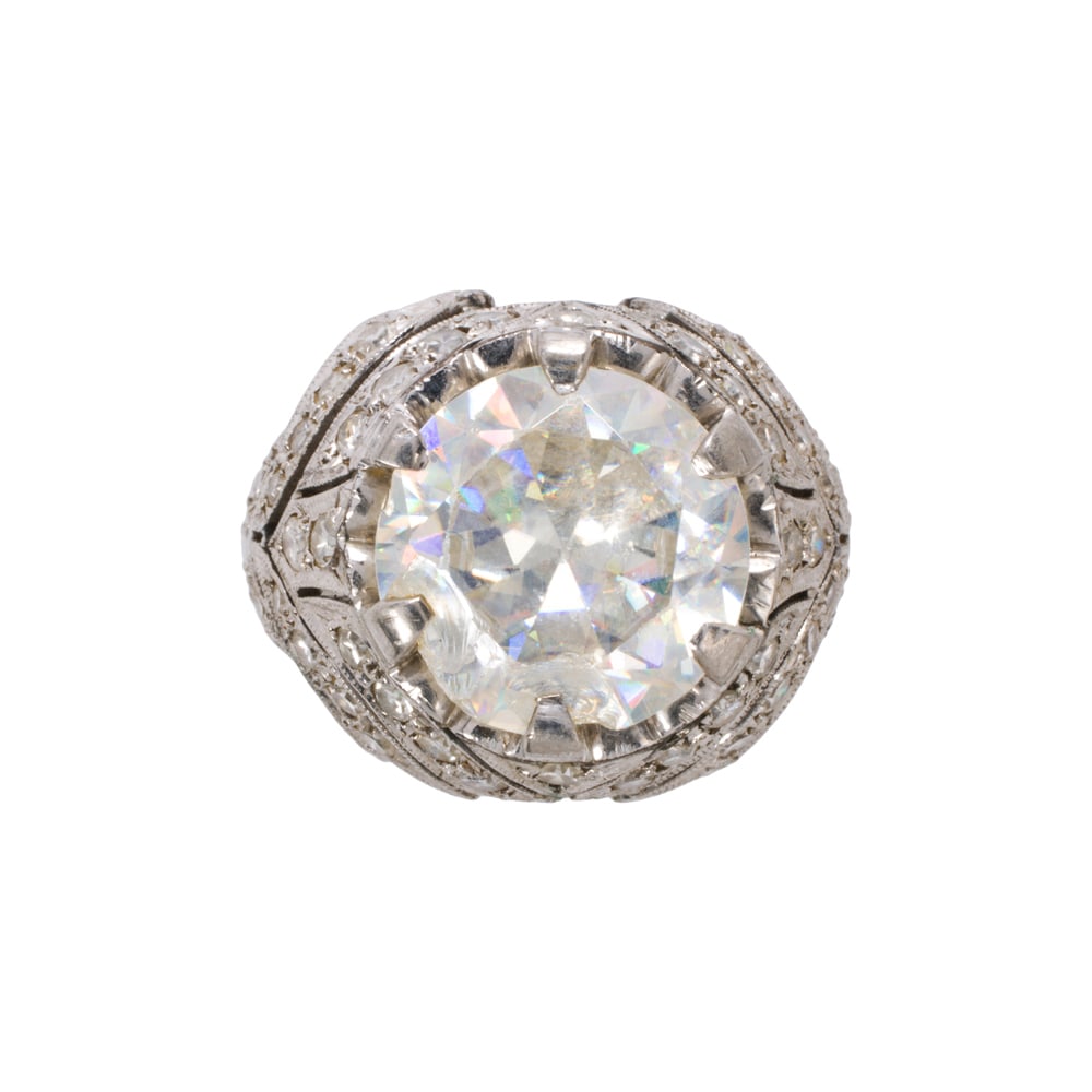 An imitation gemstone and 14k white gold ring: An imitation gemstone and 14k white gold ring The ring centering a round-cut imitation gemstone measuring 11.45 mm across; size 6 1/2; 7.05 grams