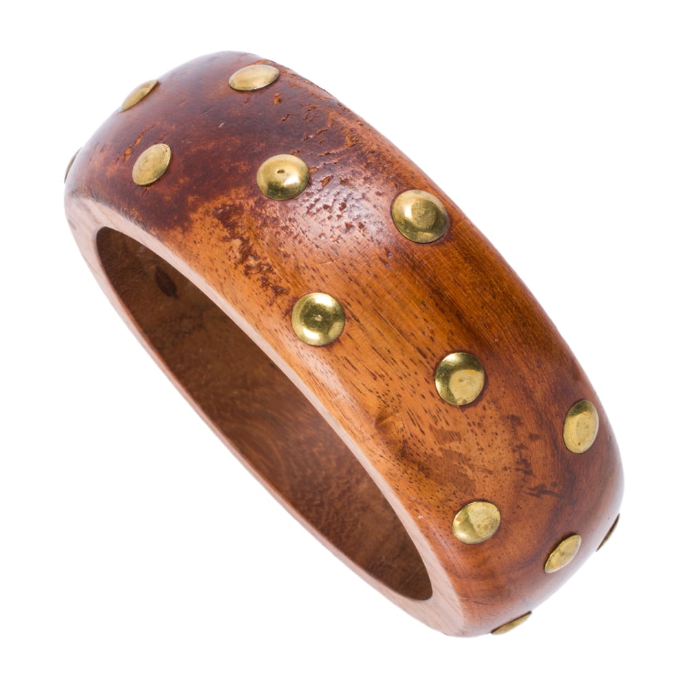 A wood and brass bracelet: A wood and brass bracelet of closed bangle design studded with brass; 59.00 grams; interior circumference: 7 3/4 in
