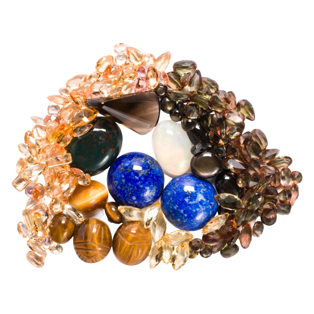 A bag of various gemstones: A bag of various gemstones comprising 38.64 carats of citrine, 16.63 carats of smokey quartz, 41.86 carats of andalusite, 11.37 carats of opal, 35 carats of lapis, 23.08 carats of tigers eye, 18.03 ca