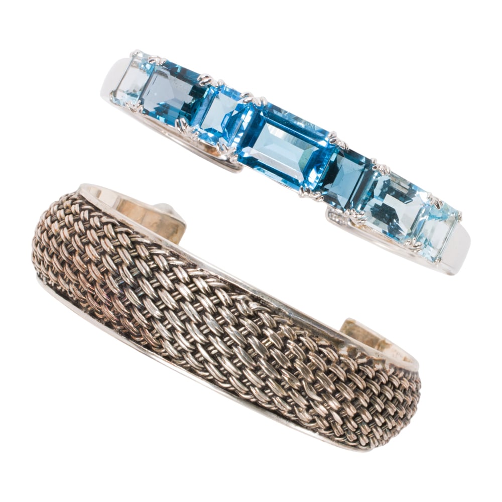 Two sterling silver cuffs: Two sterling silver cuffs Comprising one hinged cuff set with emerald-cut blue stones, together with a woven texture cuff; gross weight: 62.25 grams