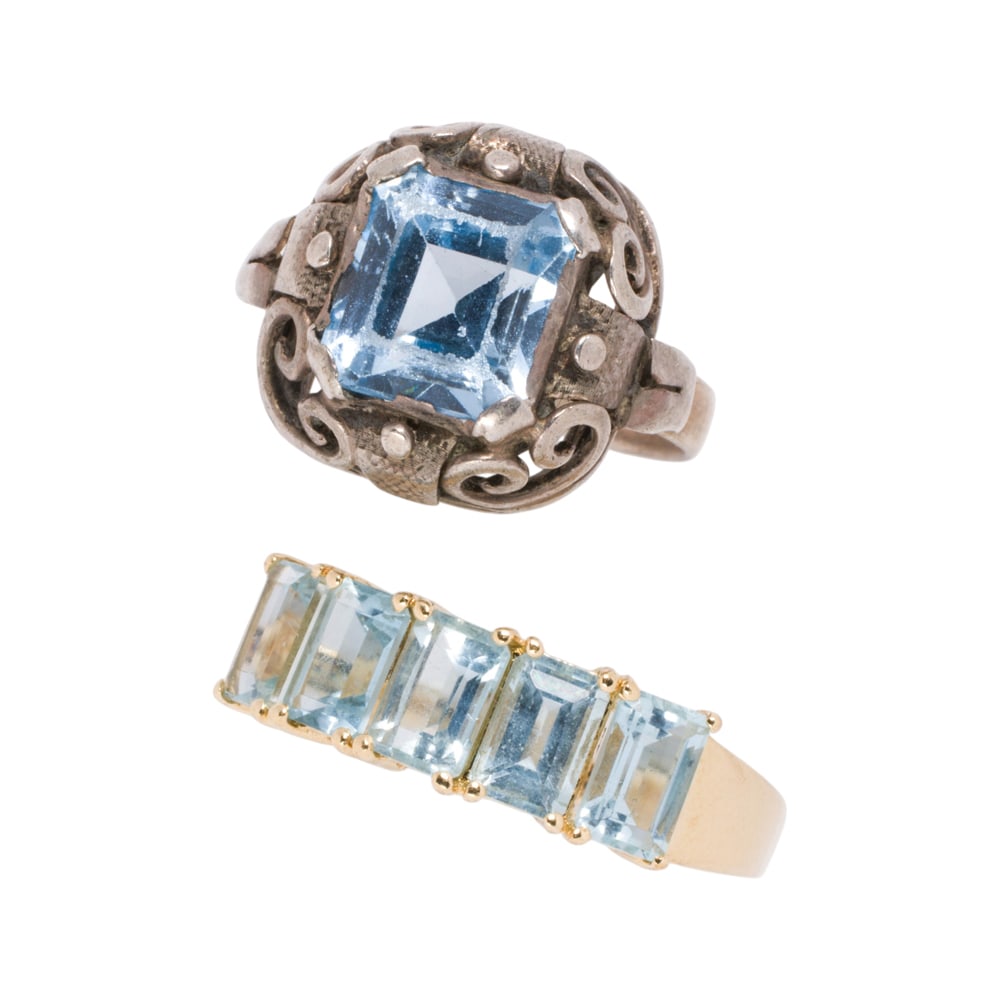 Two gem-set rings: Two gem-set rings Featuring one silver ring set with an emerald-cut topaz, together with a 14k gold ring set with five emerald-cut aquamarines; sizes 6 3/4 and 11, respectively; gross weight: 8.20