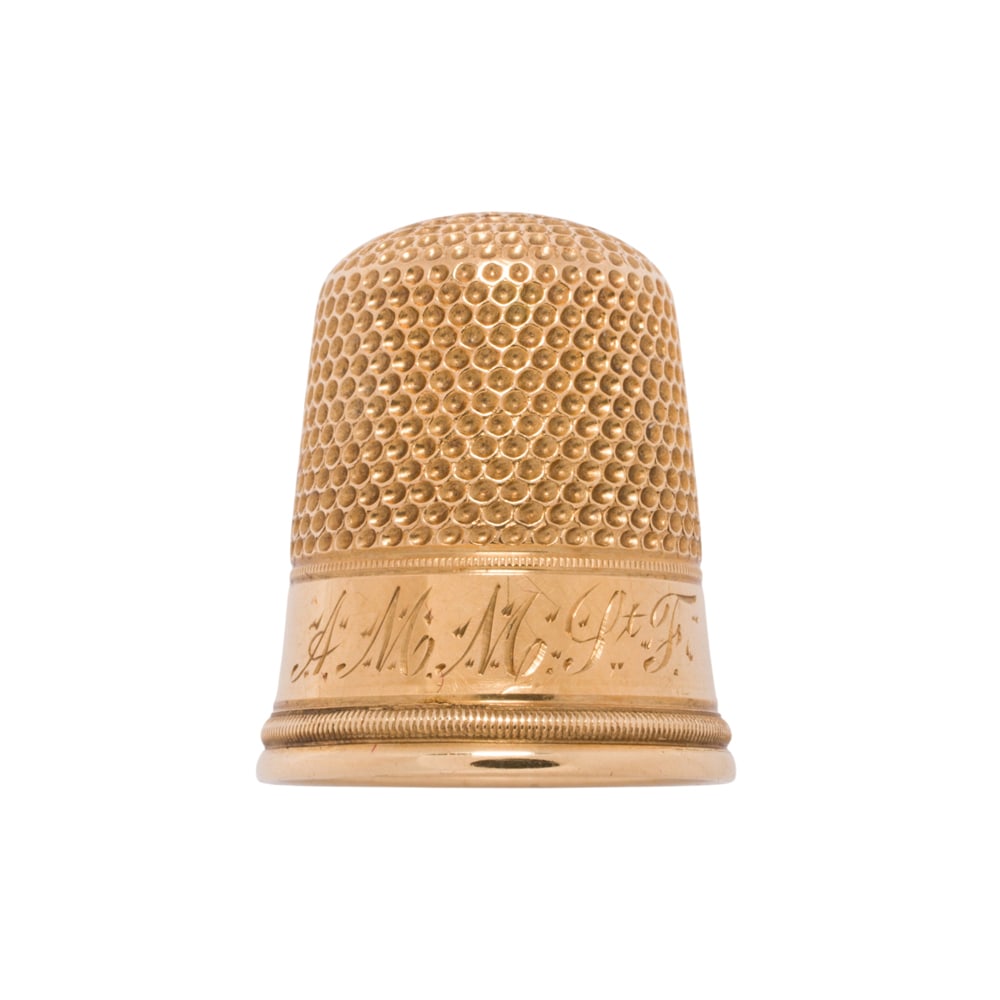 An 18k gold thimble: An 18k gold thimble 8.90 grams: accompanied by case