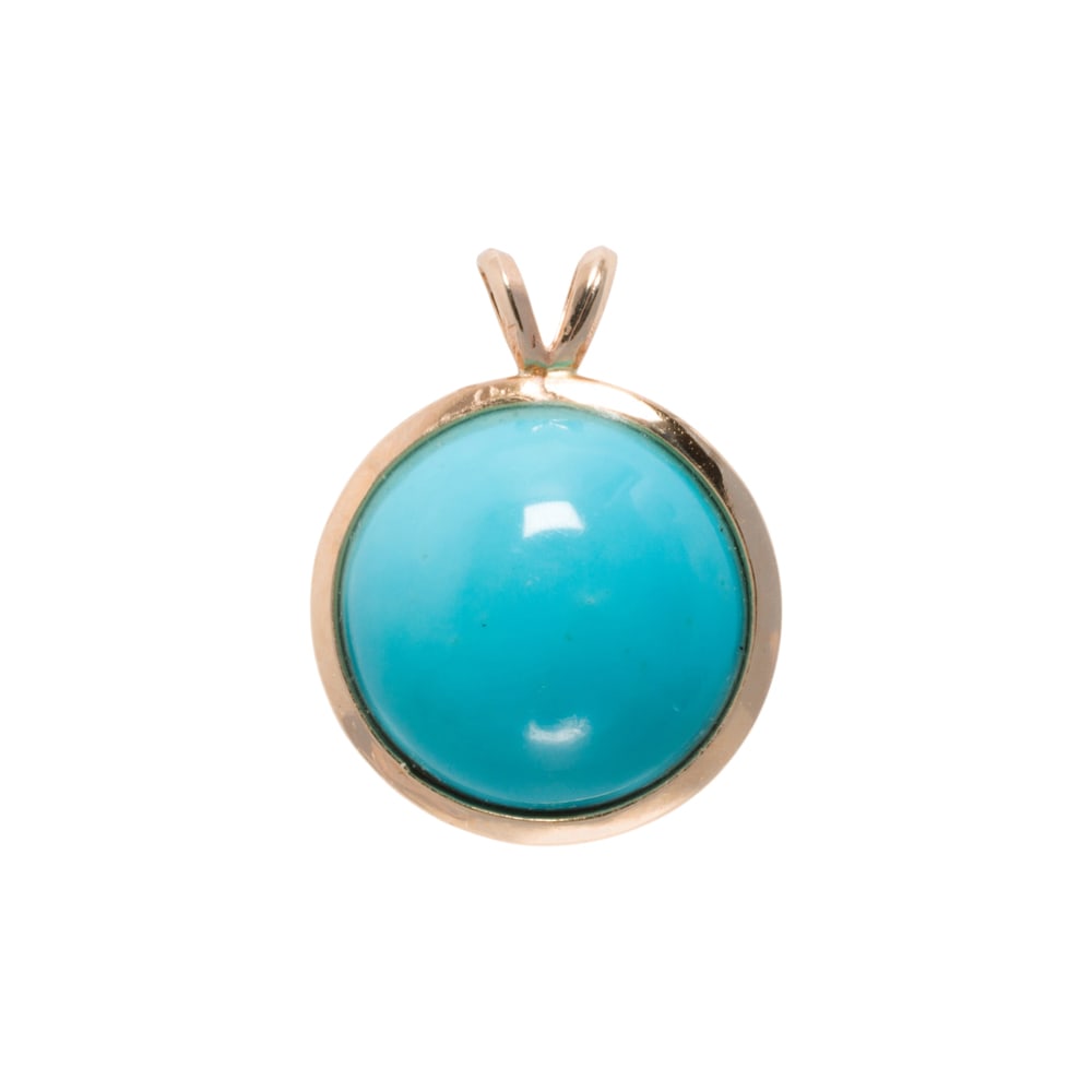 A turquoise and 14k gold pendant: A turquoise and 14k gold pendant centering a round turquoise cabochon measuring aproximatley 15.00 mm in diameter: length: 3/4 in; 3.60 grams
