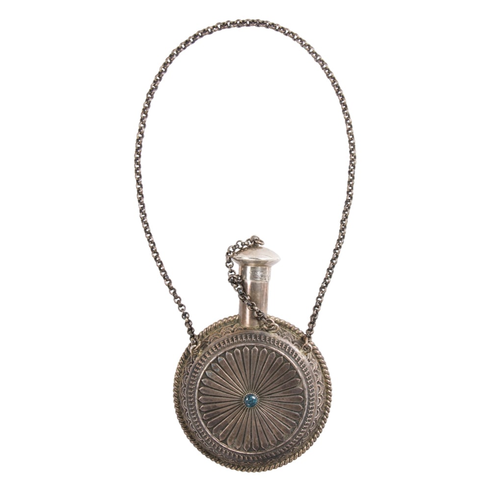 A Sunshine Reeves sterling silver flask: A Sunshine Reeves sterling silver flask Of ornate design, centering a round shaped hardstone cabochon; length: 4 1/2 in; 164.55 grams