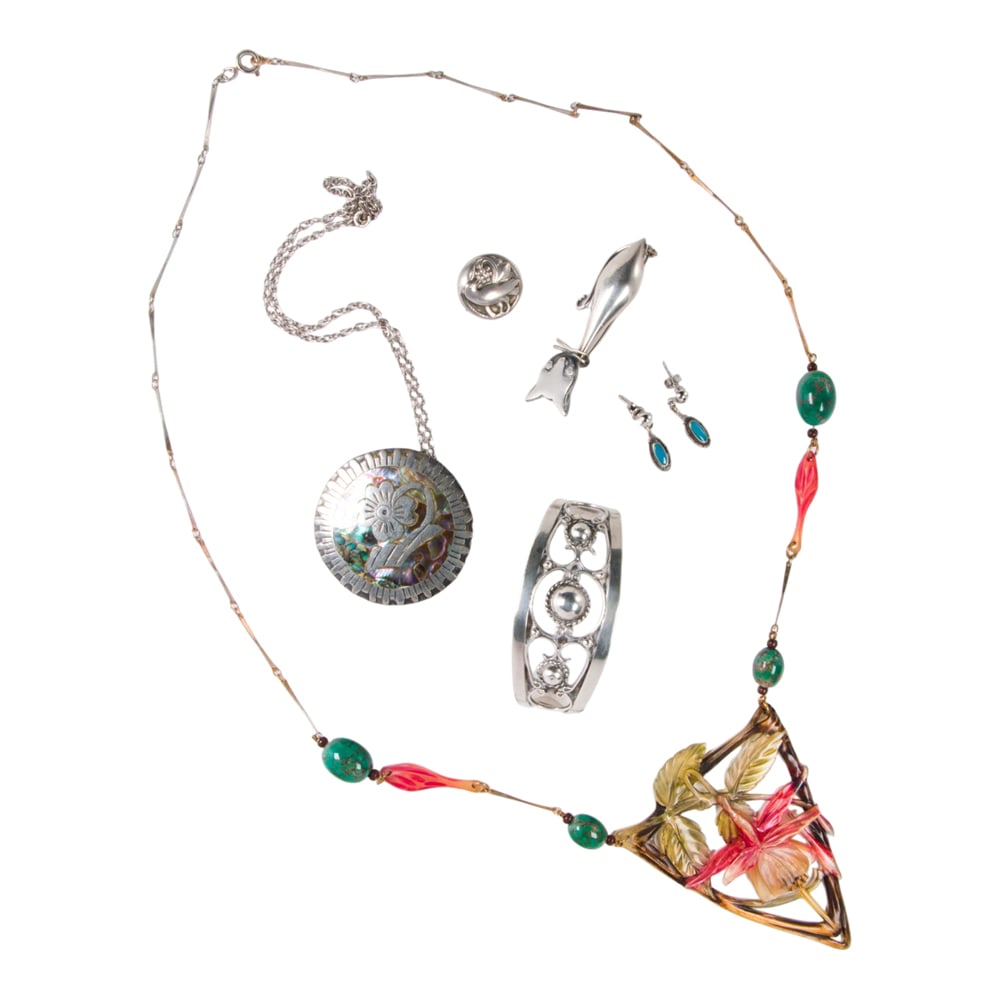 A group of silver jewelry including Georg Jensen and Taxco: A group of silver jewelry including Georg Jensen and Taxco Comprising two necklaces, two pins, a pair of earrings, and a cuff bracelets by a variety of makers including Georg Jensen; gross weight: