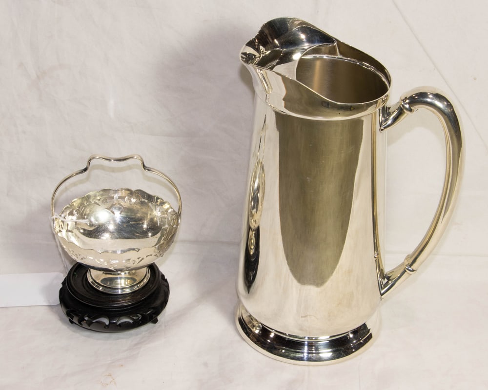 An assembled group of silver plated table articles: An assembled group of silver plated table articles, comprising: tall water pitcher with ice guard 10"h; small reticulated basket 3.5"dia [2 total]
