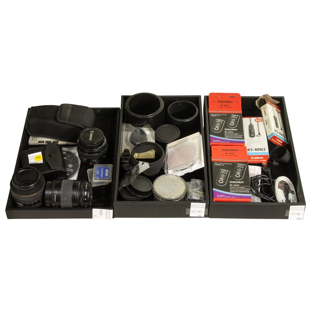 An assembled group of mainly camera lenses and accessories: An assembled group of mainly camera lenses and accessories, consisting of Canon lenses: (1) 50mm; (1) 28-80mm, (1) Sigma 30mm lens, a Sunpak digiflash 2800, (2) Yongnuo rf-603c wireless flash triggers