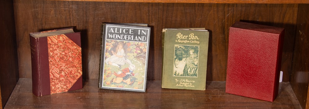 An assortment of leather bound books: An assortment of leather bound books, comprising of 'Alice in Wonderland', 'Peter Pan in Kensington Gardens', Shakespeare works, and 'The Lord of the Rings' collectors edition [4 total]