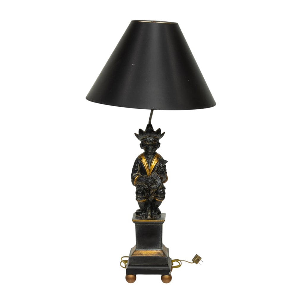 A McKenzie Childs monkey table lamp: A McKenzie Childs monkey table lamp, the figure seated and strumming a guitar and seated on pedestal, 20.75"h (figure); 34"h (overall)