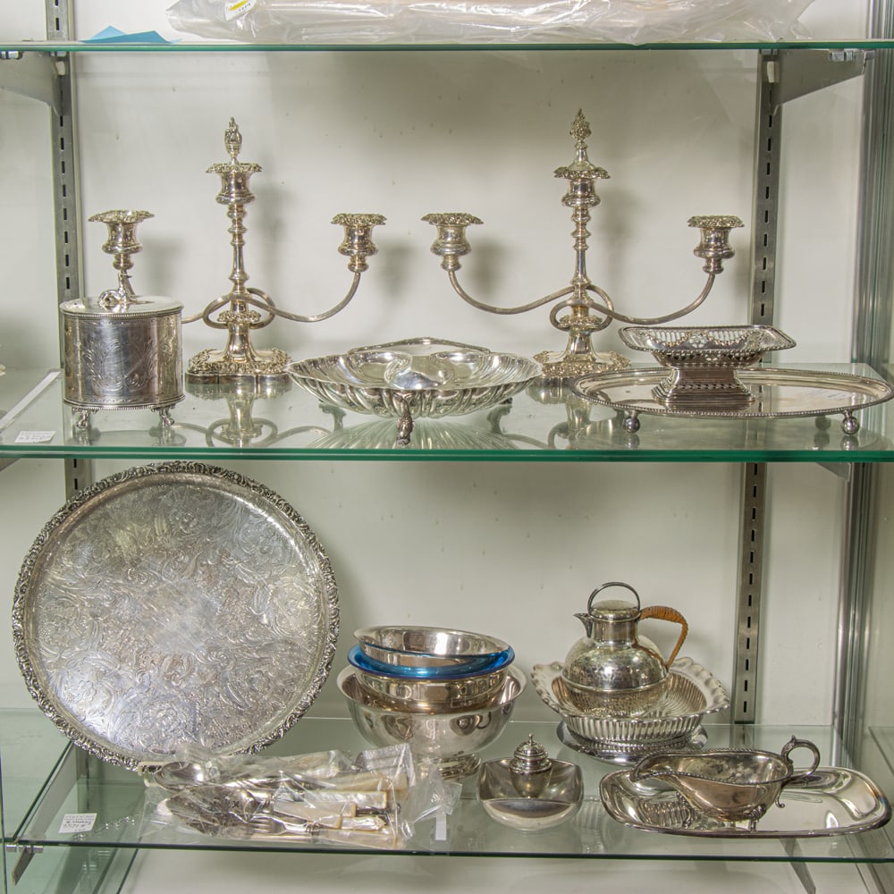 An assmbled group of silver plate including a pair of Gorham three-light candelabra: An assmbled group of silver plate including a pair of Gorham three-light candelabra, consisting: (2) candelabra 11"h x 12.5"w; (1) basket; (1) clam serving dish; (1) raised serving tray; (1) container