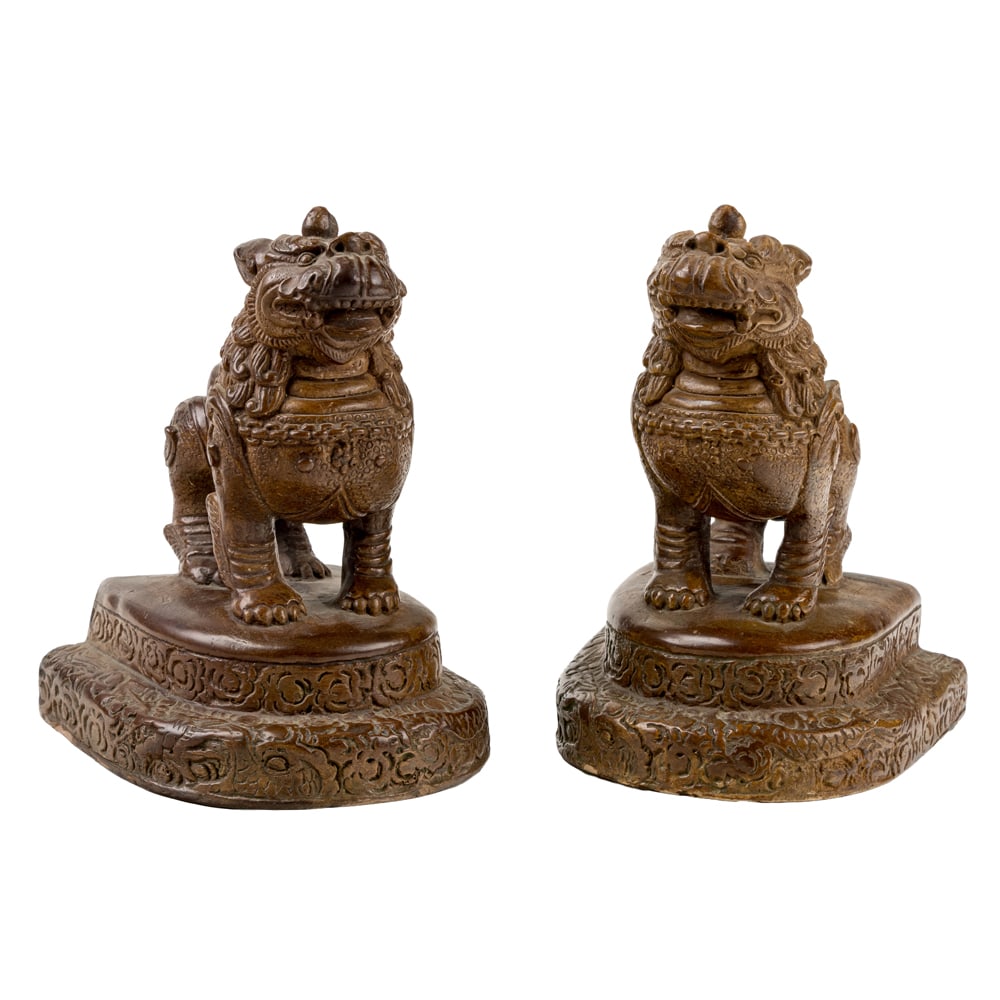 A pair of Thai bronze glazed ceramic lion-form book ends: A pair of Thai bronze glazed ceramic lion-form book ends. 20th century, 7.75" high.