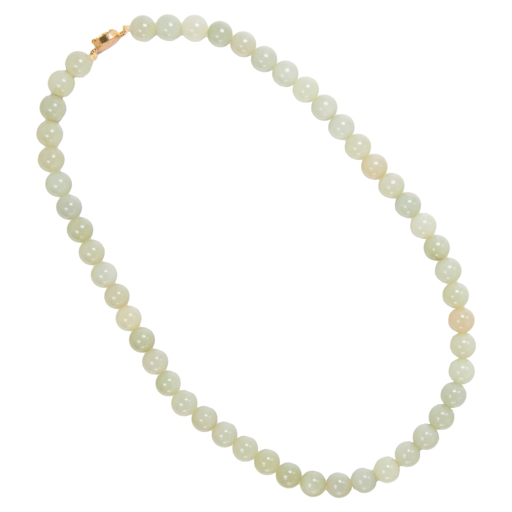A Chinese white jade necklace: A Chinese white jade necklace. Comprising 50 beads, each 0.5" across, 23.5" long.