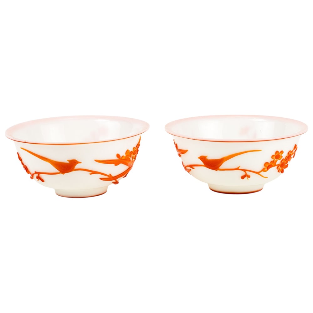 A pair of Chinese orange overlay on white glass bowls: A pair of Chinese orange overlay on white glass bowls. 20th century, 6.5" wide.