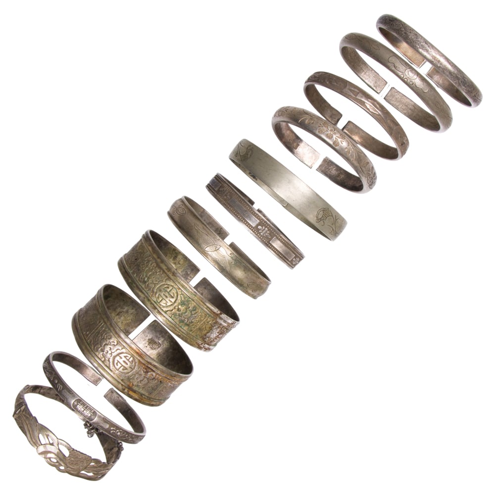 (lot of 11) Chinese silver bracelets: (lot of 11) Chinese silver bracelets. Featuring auspicious and floral motifs, Republic period, from 2.5" to 2.75" inner diameter.
