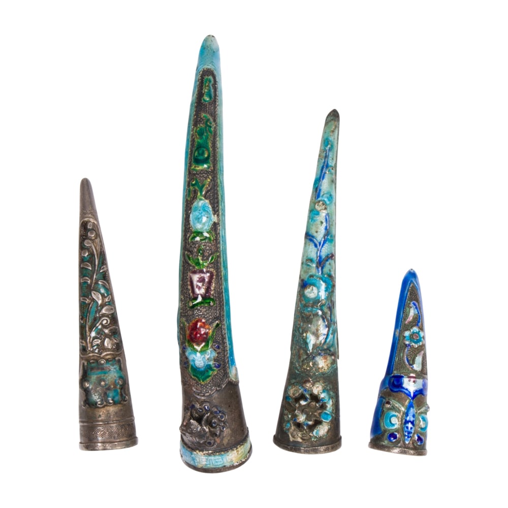 (lot of 4) Chinese silver enameled figure nail guards: (lot of 4) Chinese silver enameled figure nail guards. Featuring floral design, late Qing period, from 1.75" to 4" across.