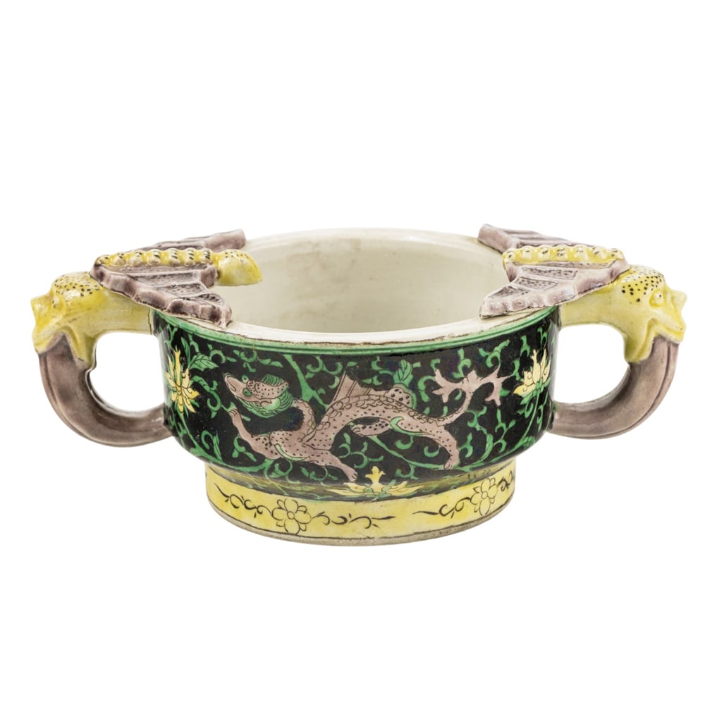 A Chinese famille verte libation cup: A Chinese famille verte libation cup. Qing dynasty, 6.5" wide. Condition: one handle damaged.