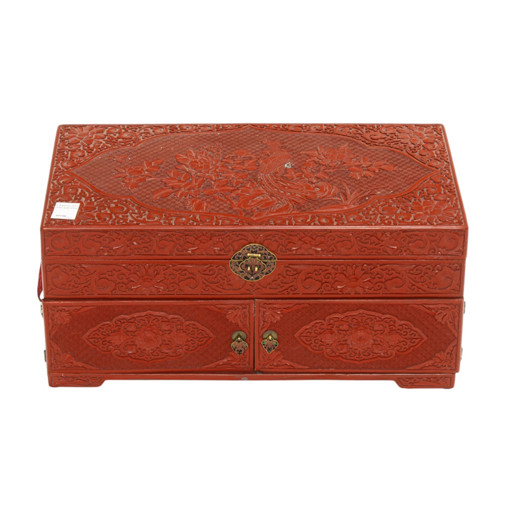 A Chinese cinnabar lacquer trunk: A Chinese cinnabar lacquer trunk. 20th century, 10.25"h x 22"w x 12"d.