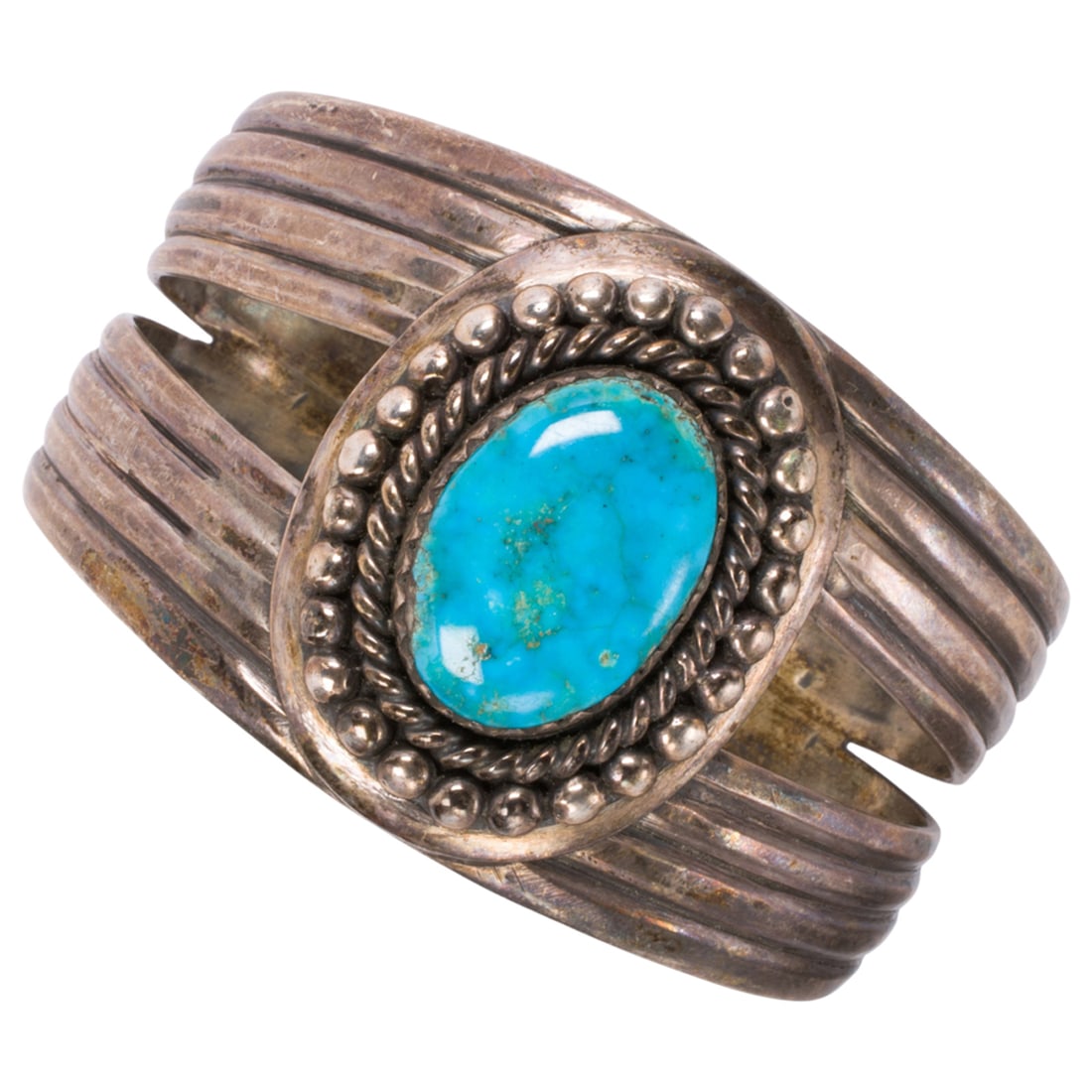 A Native American turquoise and sterling silver cuff bracelet: A Native American turquoise and sterling silver cuff bracelet Set with an oval-shaped turquoise cabochon measuring 23.13 x 16.07 mm; stamped "BB"; length: 6 5/8 in; 68.25 grams