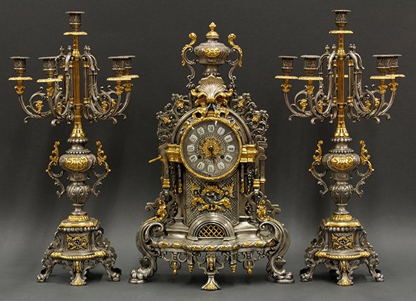 Napoleon III style clock with garniture: (lot of 3) Napoleon III style clock with garniture, the monumental clock with urn finial and gilt metal acanthus medallion surmounting the round dial set with enameled tile markers, gilt accents, and 