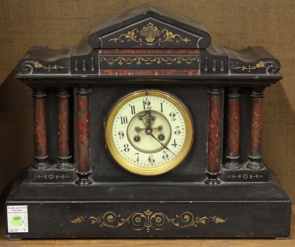 Continental Victorian slate and marble mantle clock: Continental Victorian slate and marble mantle clock, the architectural form with gilt reserves surmounting the circular dial with Arabic markers and an open escapement, the pillars executed in variega